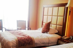 A hotel room with a large bed, a bedside table with a lamp, and a window with curtains. - Tianxinliang Hotel (Beijing)