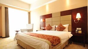 A hotel room with a large bed, a bedside table, a lamp, and a view of the outdoors. - Tianxinliang Hotel (Beijing)