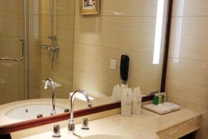 A bathroom with a sink, mirror, and shower. - Tianxinliang Hotel (Beijing)