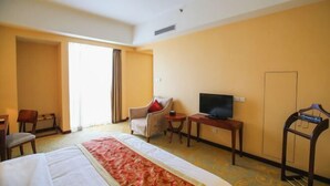 A hotel room with a bed, a desk, a chair, a television, and a wardrobe. - Tianxinliang Hotel (Beijing)