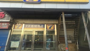 A hotel entrance with a prominent number 7 sign, indicating the hotel name.