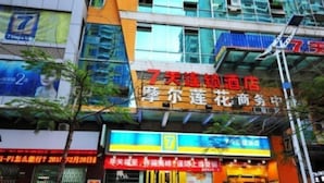 A hotel facade with a prominent red sign indicating it is a 7-day hotel. - 7 Days Inn (Xiamen)