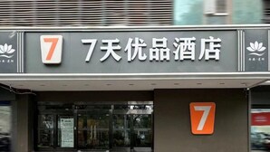 Entrada de hotel con un letrero grande con el número 7 y caracteres chinos.