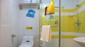 A bathroom with a toilet, a glass shower enclosure, and a sink. - 7 Days Inn Harbin Railway Station Qiulin Shop (Harbin)