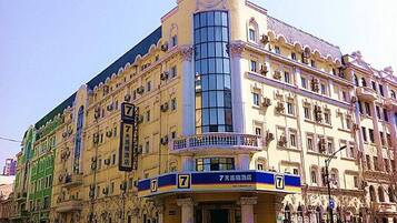 A multi-story building with a prominent '7' sign, indicating a hotel or similar establishment.