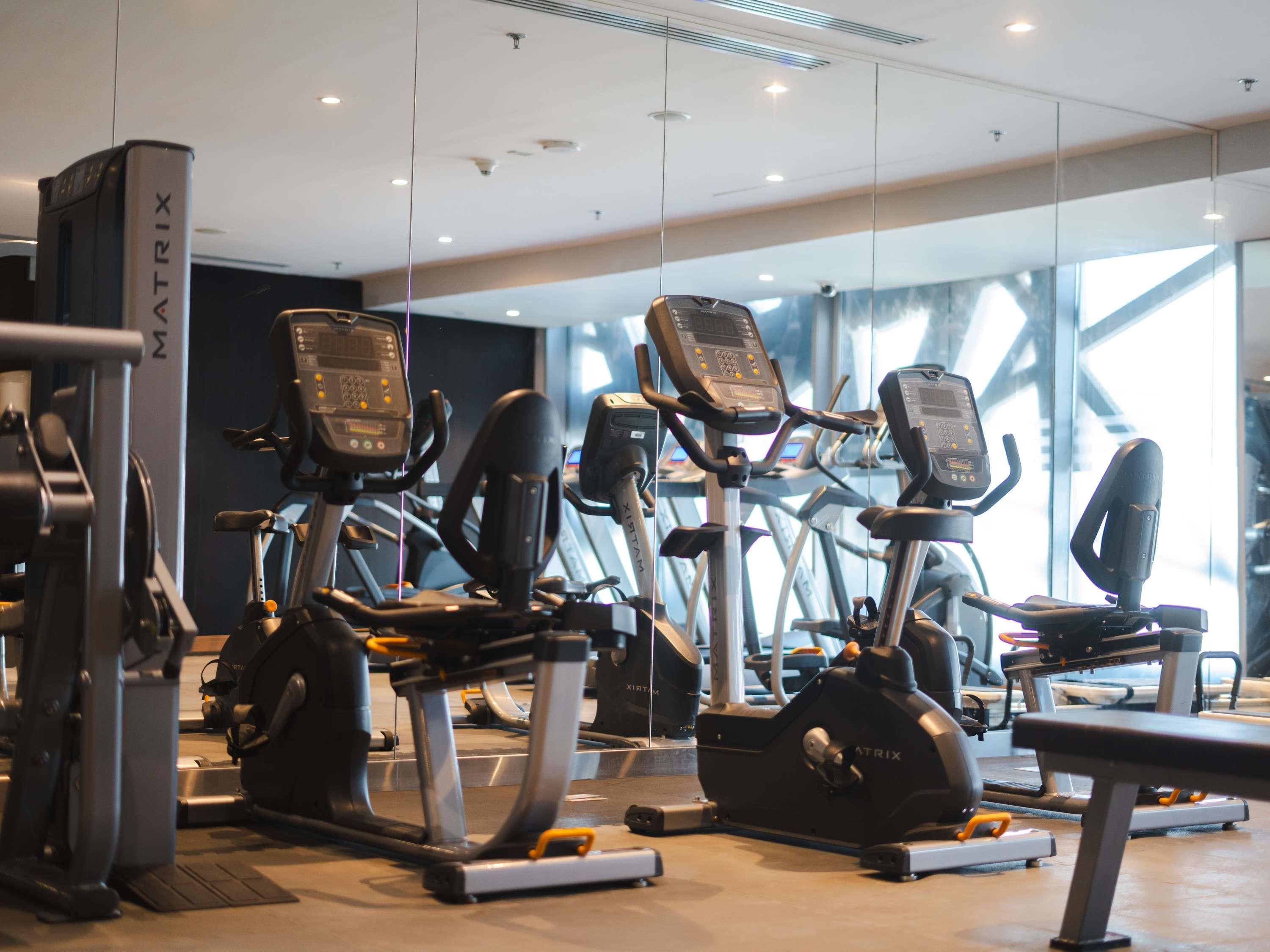 A gym with multiple treadmills and exercise equipment.
