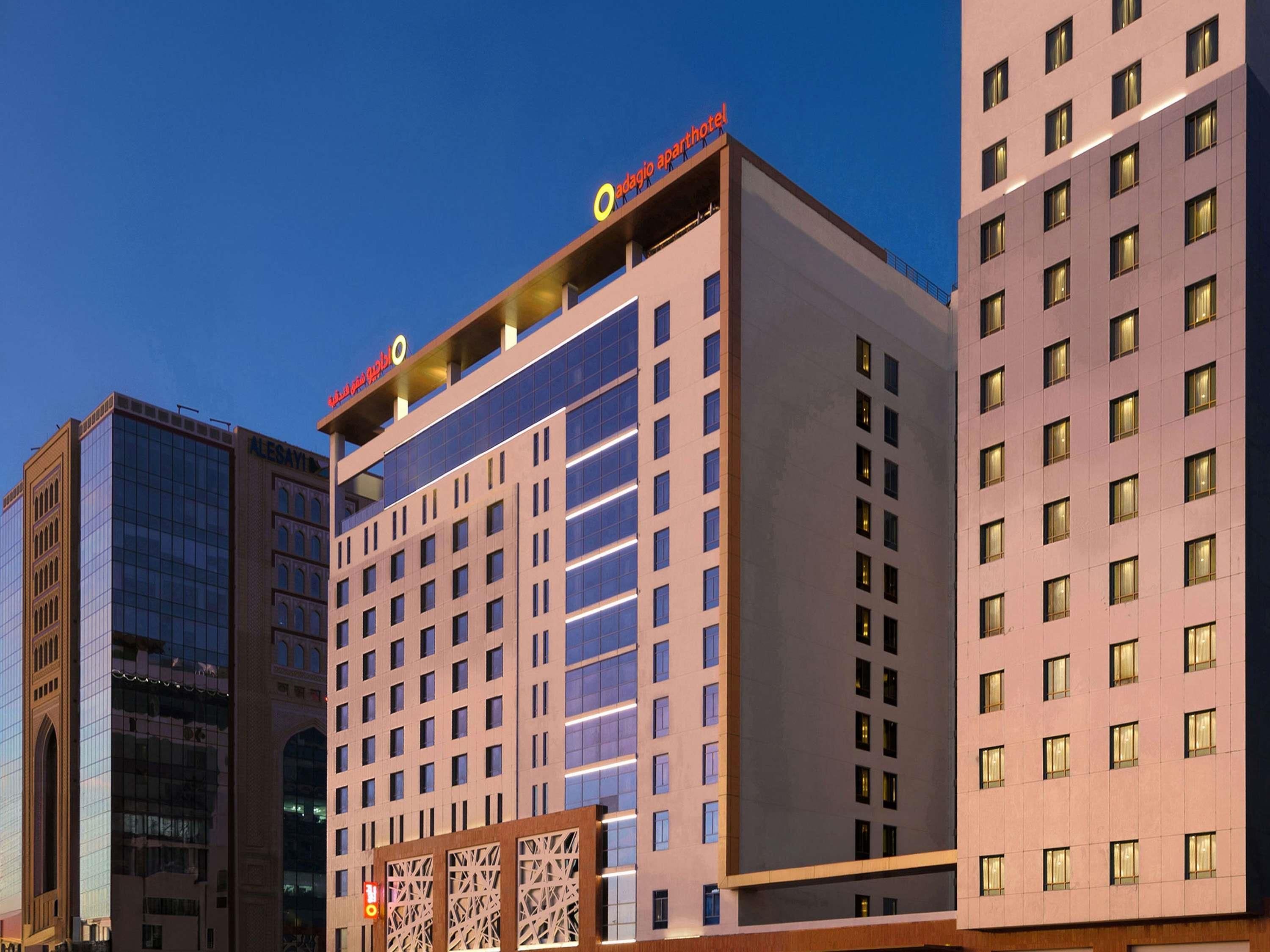 Un hotel de varios pisos con fachada moderna, destacando un letrero grande en la parte superior.