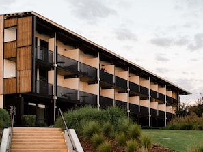 A multi-story building with a modern architectural design, featuring balconies and a staircase leading to the entrance. - The Sebel Yarrawonga Silverwoods (Yarrawonga)