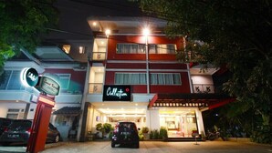 A building with a sign reading "Sweet Collection" and a car parked in front. - Collection O Sweet Karina (Bandung)