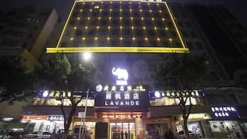 A hotel with a prominent sign reading 'LAVANDE HOTEL' and a large illuminated elephant symbol.