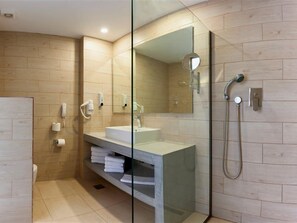 A modern bathroom with a glass shower enclosure, a white sink, and a towel rack. - Alykanas Village Resort (Zakynthos)