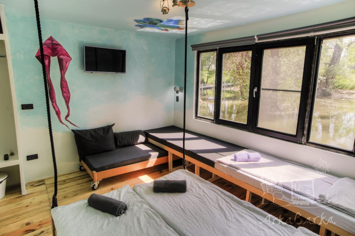 Deluxe Quadruple Room | Minibar, in-room safe, desk, laptop workspace