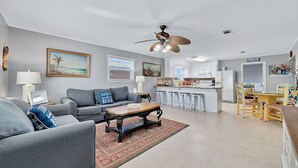 A modern living room with a gray sofa, a wooden coffee table, and a ceiling fan. - PRIVATE HOME, CLOSE TO THE BEACH, GREAT FOR FAMILIES, CONVENIENT TO EVERYTHING (Gulf Shores)