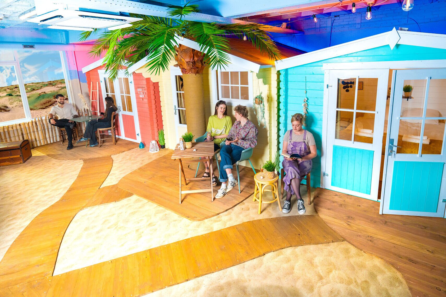 A room with a wooden floor, a table, and chairs.