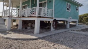 A two-story house with a covered porch and a small deck. - Cabanya Azul with view of Atlantic and small Beach within walking distance (Buckley's Settlement)