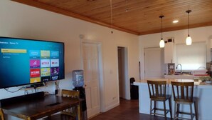 A modern kitchen with wooden cabinets, a built-in island, and pendant lighting. - Cabanya Azul with view of Atlantic and small Beach within walking distance (Buckley's Settlement)