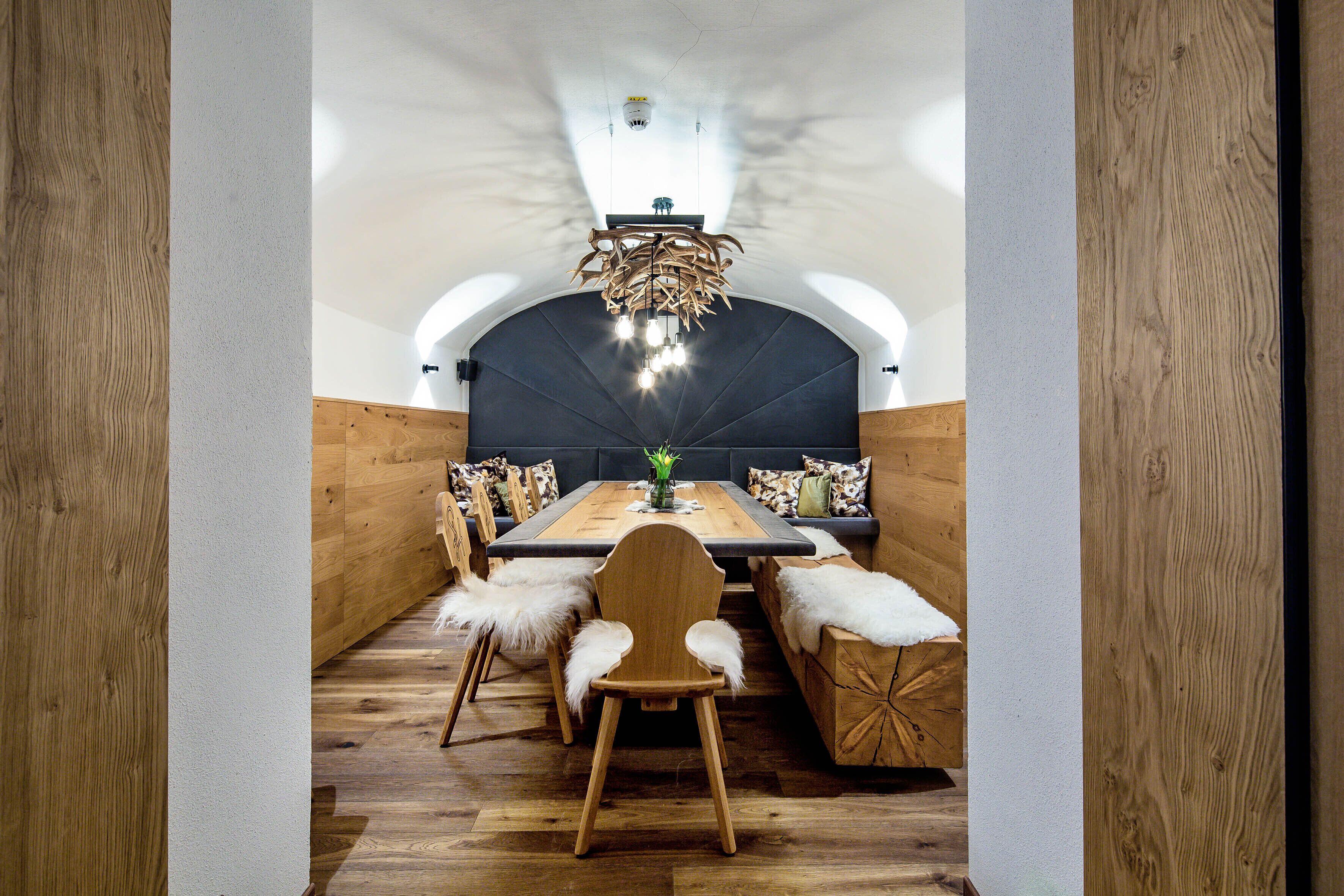 A dining area with a wooden table, chairs, and a bench.