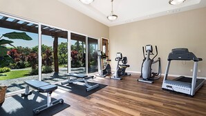 A spacious home gym with a treadmill, elliptical, and weight bench. - Waikoloa Beach Villas M2 (Waikoloa)