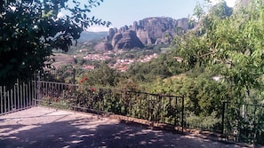 Panoramic views of the town nestled in a lush valley, surrounded by rolling hills and greenery.