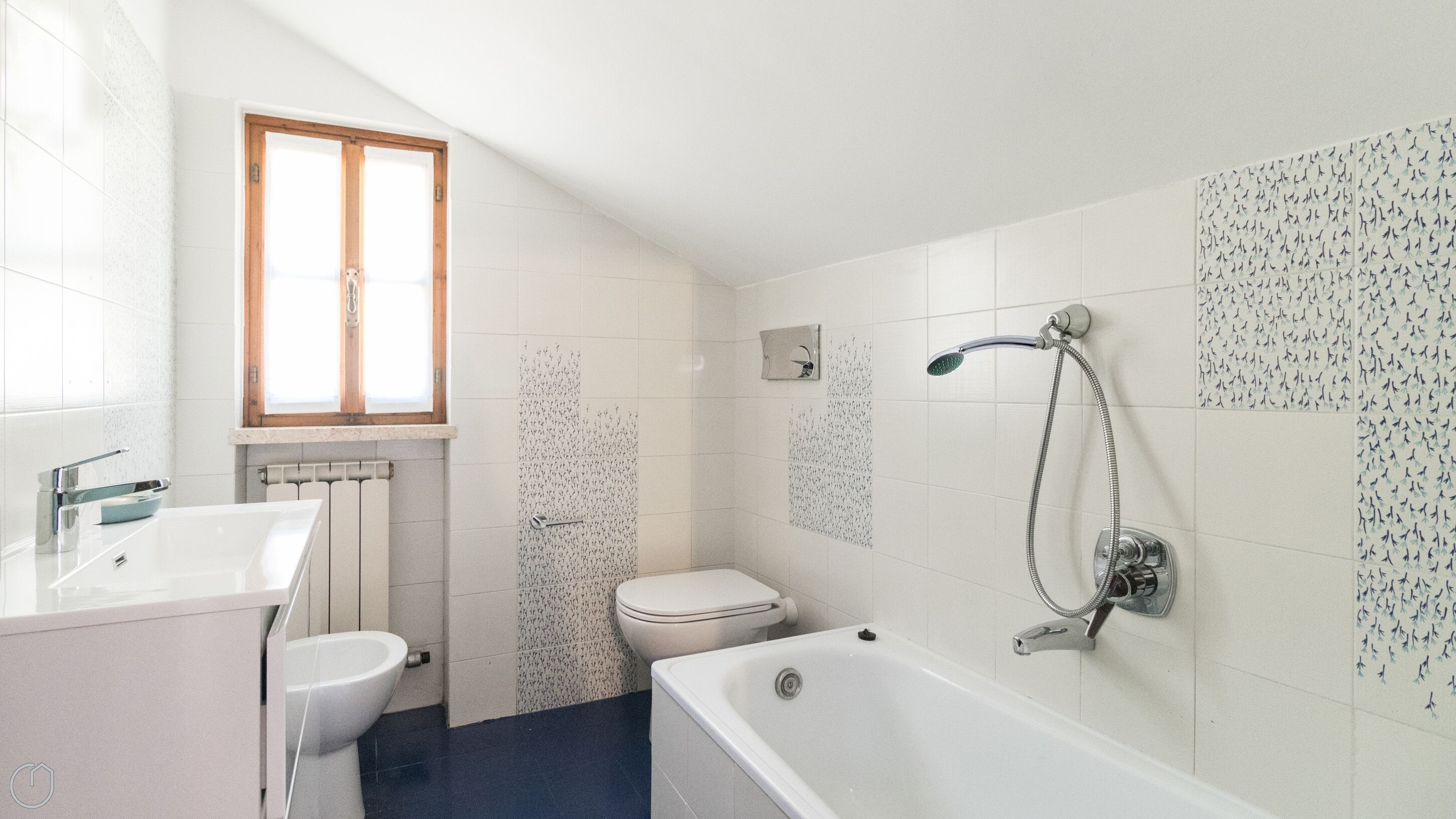 A bathroom with a bathtub, toilet, and sink.