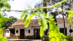 A building with a tiled roof and a sign that reads "Alejandro."