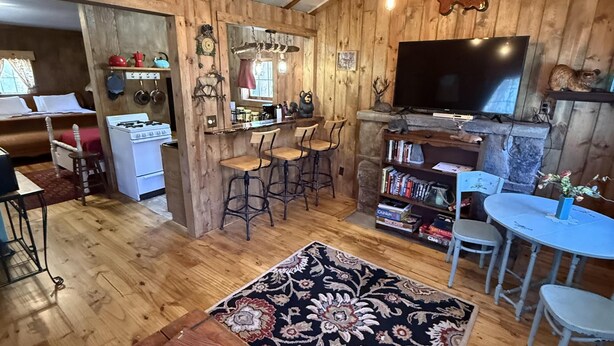 A rustic cabin interior with a kitchen, dining area, and living space. - Little Mosser-Awesome Views! Very Quiet! (Estes Park)
