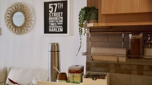 A kitchen with a stainless steel kettle, a small decorative container, and a towel rack. - Cozy studio in the heart of Recoleta (CABA)