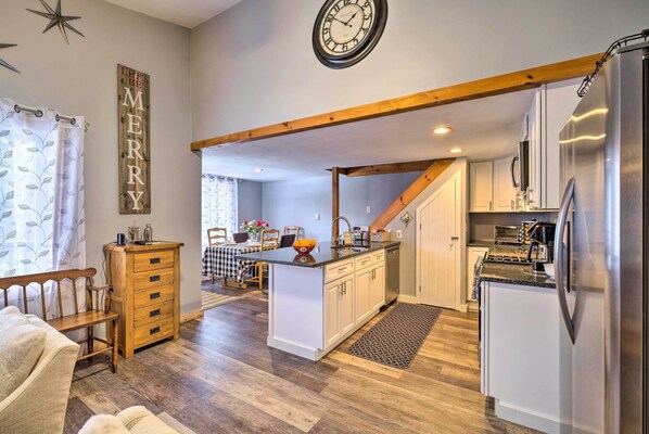 Enjoy cooking in this well-equipped kitchen with a refrigerator, oven, and microwave, and dine in the adjacent dining area.