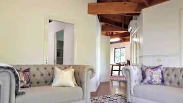 A spacious cottage with a unique feature ceiling throughout, featuring hand-selected furnishings.