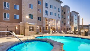 A swimming pool with a metal ladder, surrounded by a fence. - Free Breakfast. Pool & Hot Tub. Gym. Near Traverse Mountain Shopping Center! (Lehi)