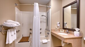A bathroom with a shower, a sink, and a mirror. - Free Breakfast. Pool & Hot Tub. Gym. Near Traverse Mountain Shopping Center! (Lehi)