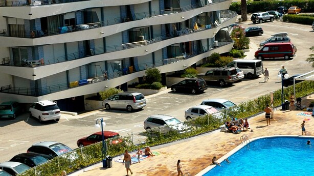 A multi-story hotel with a swimming pool, outdoor seating, and a view of the sea. - ROCAMAURA II 1-5 (Estartit)