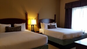 A hotel room with two beds, a nightstand with a lamp, and a window with curtains. - Free Breakfast. Gym. Near Mercy Hospital Northwest Arkansas! (Rogers)