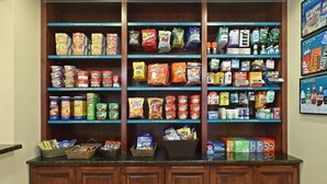 A snack, candy, and sundries section with various packaged goods and beverages.