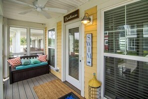 A covered porch with a bench, a ceiling fan, and a sign that reads "Beachhouse". - Captain`s Quarters - 179 Leeward Way, Cottage #6 (Ottawa)