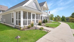 A single-story house with a covered porch, a well-maintained lawn, and a clear sky. - Our Happy Place #2 (Ottawa)