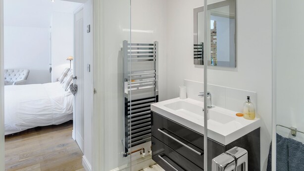 A modern bathroom with a glass partition, a white sink, and a mirror. - The Old Dairy At Wooton - UKC4355 (East Chiltington)