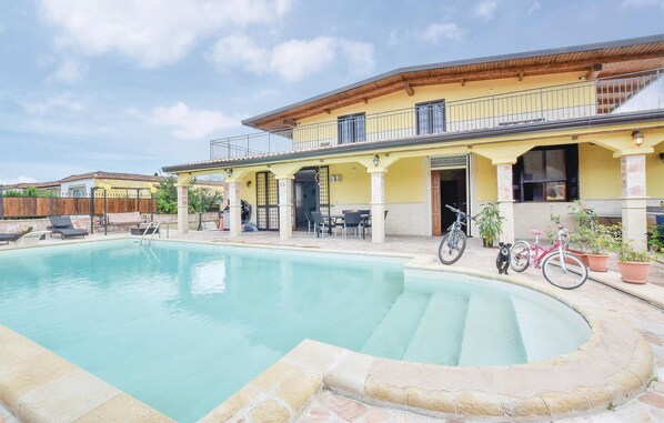 Enjoy a refreshing dip in the pool from the comfort of your patio, complete with outdoor seating and a balcony above.