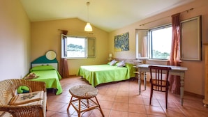 A room with two beds, a desk, a chair, and a window with curtains. - 3 bedroom cozy home in Castellammare del G. (Castellammare del G.)