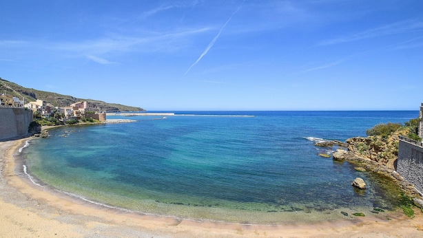 A coastal town with clear blue waters, a sandy beach, and buildings along the shore. - 3 bedroom cozy home in Castellammare del G. (Castellammare del G.)