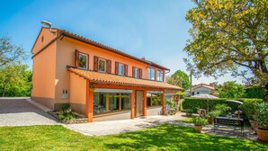 A two-story house with a tiled roof, large windows, and a well-maintained lawn. - 3 bedroom amazing home in Stanjel (Stanjel)