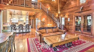 Télévision, cheminée, table de tennis de table, livres