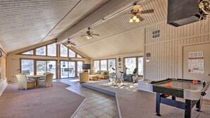 A spacious indoor area with a pool table, comfortable seating, and large windows allowing natural light. - Steamboat Ski Getaway w/ Balcony & Resort Views! (Steamboat Springs)