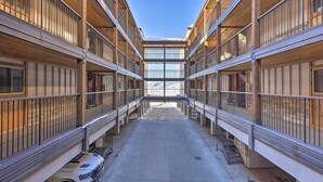 A multi-level building with balconies and a central open space. - Steamboat Ski Getaway w/ Balcony & Resort Views! (Steamboat Springs)