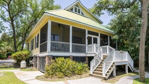 A two-story house with a covered porch and a staircase leading to the second floor. - Lloyd's Lodge: Spacious Fripp Island Retreat with Golf, Beaches, Pools, and Screened Porch! (Fripp Island)