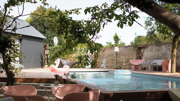 A backyard with a swimming pool, outdoor furniture, and a stone wall. - Former flour mill 20 minutes from La Rochelle: sleeps 15 to 25 (mauzé on the mignon)