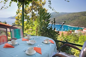 A table set for two with a view of the sea and hills. - Apartment 2023/28732 (Istria - Rabac), 500m from the beach (Rabac)
