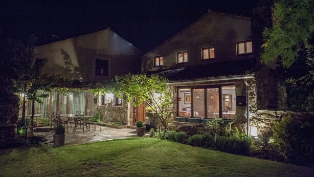 A two-story house with a patio and a dining area.