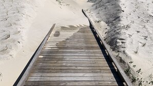 A wooden boardwalk leading to a sandy beach with ocean views. - "No Pressure"  Beautiful beach front home (Port St Joe)