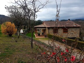 Relax in a tranquil countryside setting, surrounded by lush greenery and vibrant flowers.